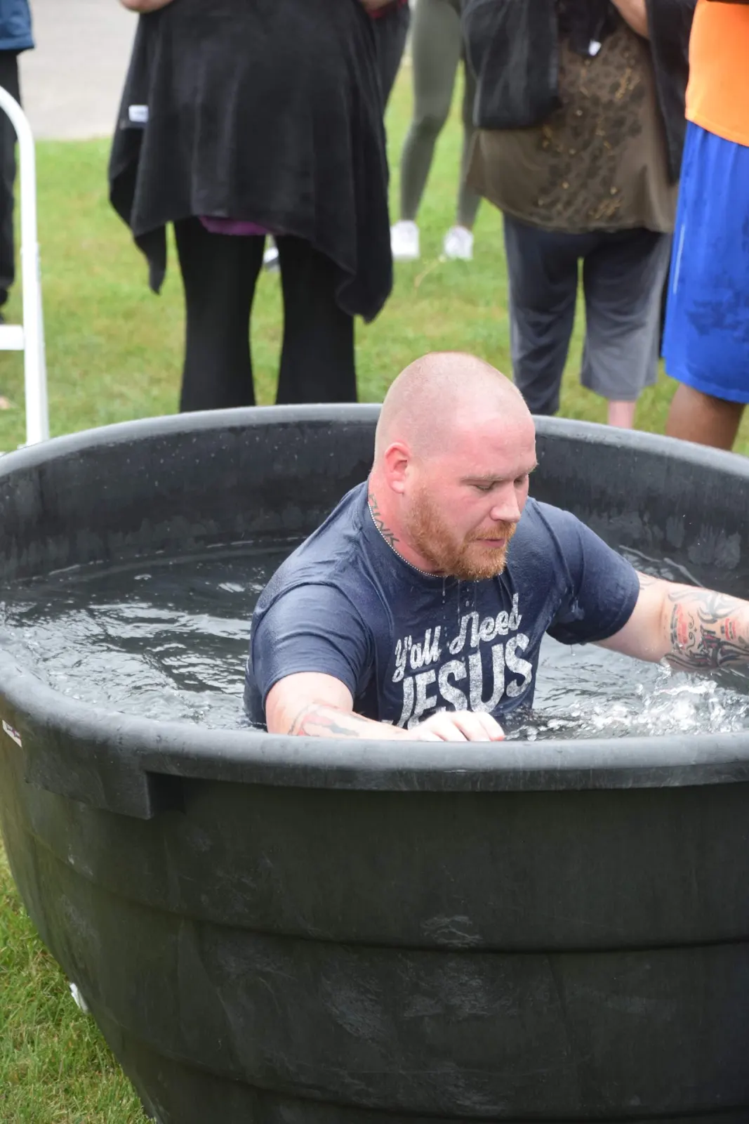 A man being baptized during an outdoor baptism service at The River Church