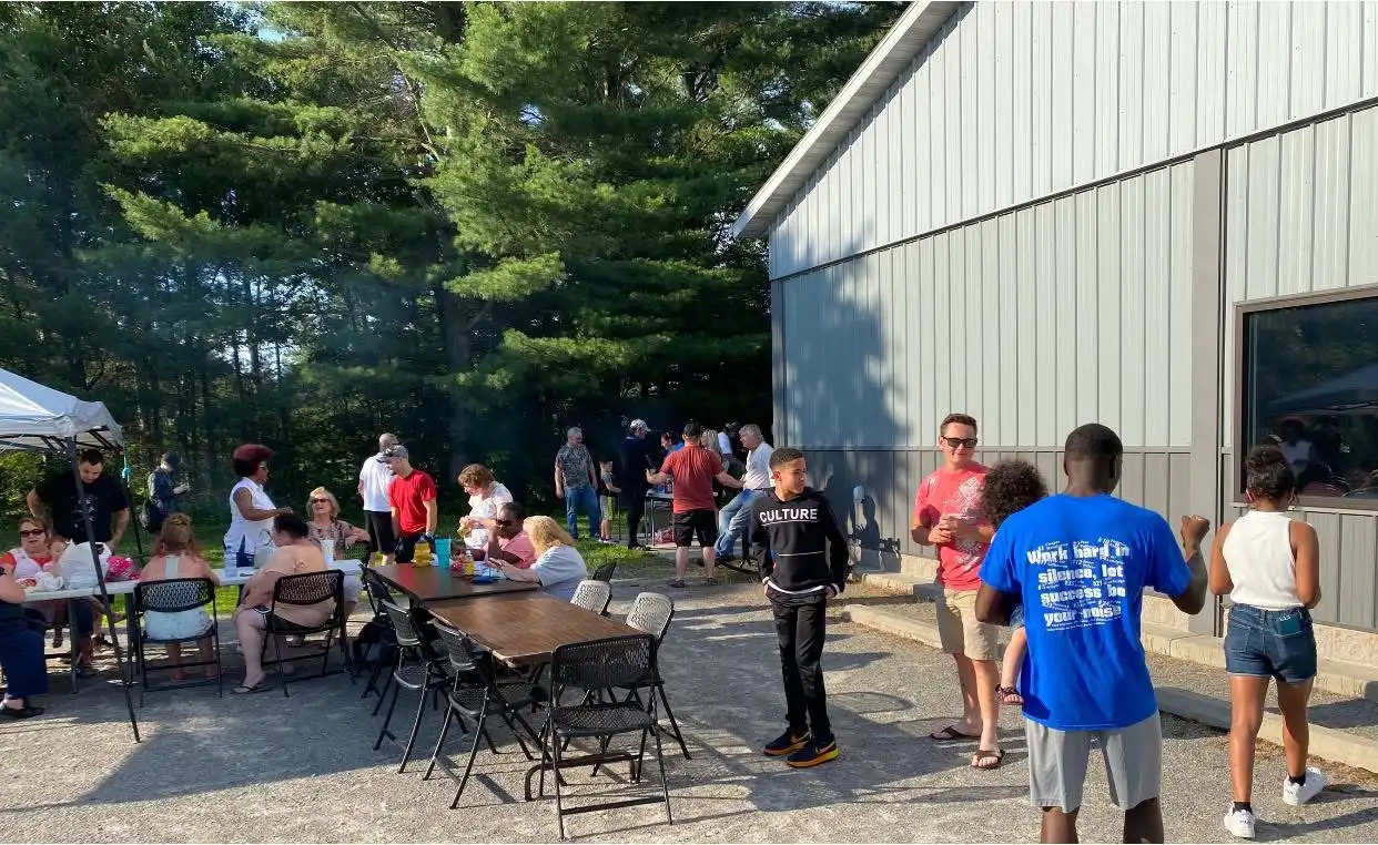 Church family gathering outside for a summer cookout at The River Church
